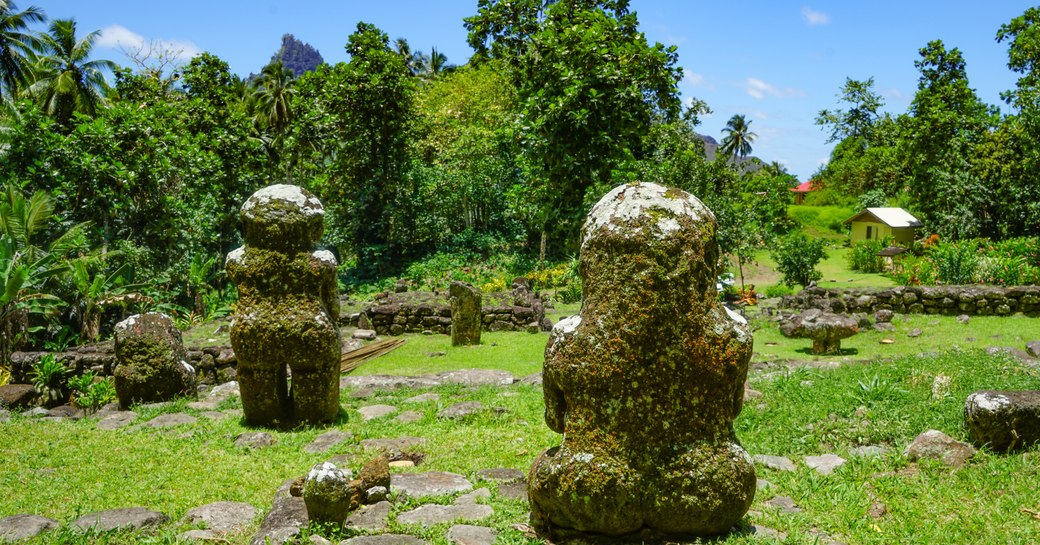 sculptures named Tikis sat in a public garden in French Polynesia
