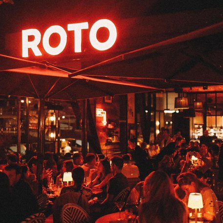 Guests lit up by Roto's iconic neon sign 